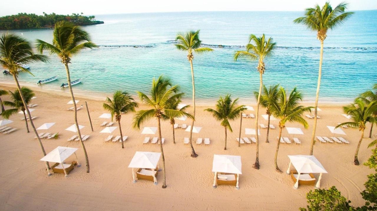 Casa de Campo beach with palm trees and cabanas
